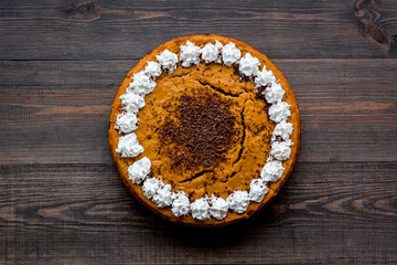 Pumpkin pie for thanksgiving day on dark wooden background top view copyspace