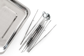 Set of dentists tools near cuvette on white background  top view copyspace