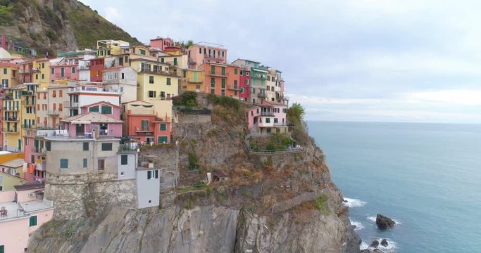 Amazing aerial view of Manarola village on cliff rocks and turquoise sea.Stunning view of beautiful and cozy town in Cinque Terre Reserve,Liguria,Italy,Europe.Travel destination, adventure concept.