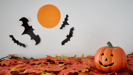 Happy Halloween pumpkin head jack lantern with bat and moon on leaves