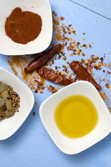 Spices and Olive Oil on Blue Background