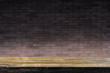 Wood table at orange brick wall texture background