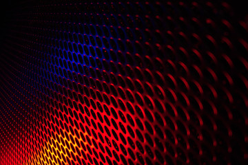 Black grid speaker texture with red and blue colors