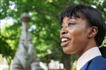african woman being surprised at dinosaur