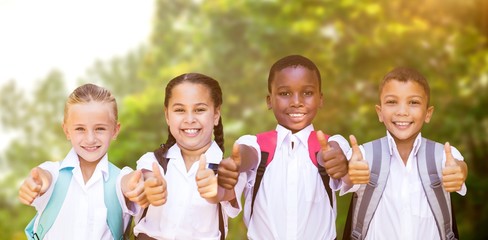 Composite image of portrait of students showing thumbs up sign