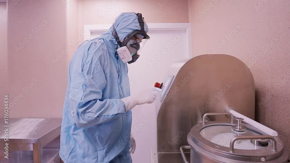 Poster running the research. male scientist inserting samples into automatic biochemical analyzer working i