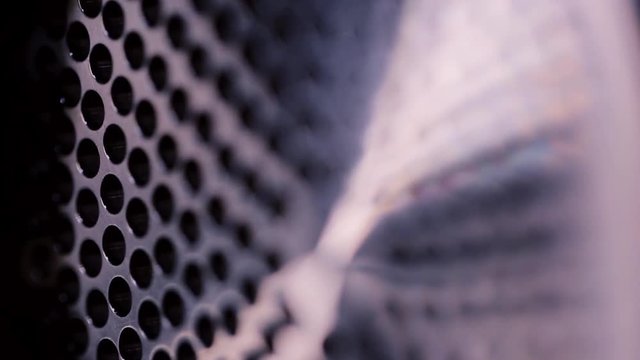 Metal net circle texture background. Abstract holes in the metal macro. Round holes centrifuge close-up