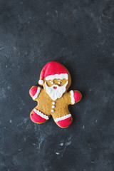 Ginger men with colored glaze on a gray background .. Gingerbread. Christmas cookies. Ginger man in a colored sweater. Gingerbread Santa