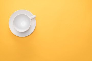 Empty coffee or tea cup on a yellow background