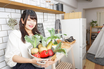 young woman holding vegetables 