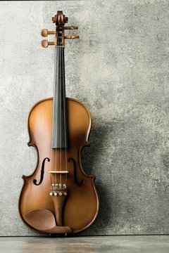 vintage violin on concrete background