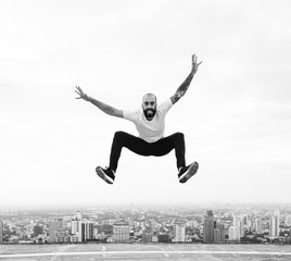 Fototapeta na wymiar Man jumping on a rooftop