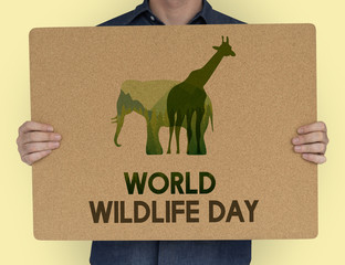 Man holding a sign with World Wildlife Day