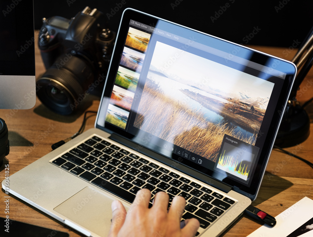 Wall mural man editing photos on a computer
