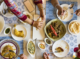 A group of Indian people is having lunch together