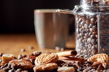Aroma coffee chocolate cookies and spices on the wooden table. Dark wooden background. Top view. Close. Closeup.