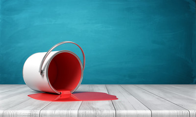 3d rendering of a metal bucket overturned on a wooden desk with red paint leaking out in a puddle. © gearstd