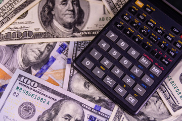 Modern calculator on a one hundred dollar bills