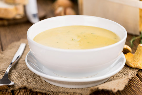 Fresh made Creamy Chanterelle Soup on a rustic background