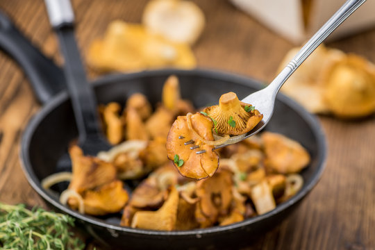 Fresh made Fried Chanterelles on a rustic background
