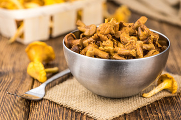Wooden table with Canned chanterelles, selective focus