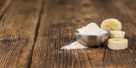 Ground Banana on wooden background; selective focus