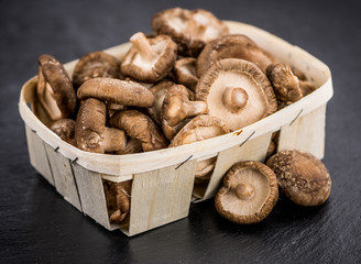 Shiitake mushrooms on a vintage slate slab, selective focus