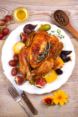 Chicken with figs, corn on cob, grape, plums and blackberry, overhead