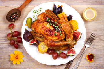 Chicken with figs, corn on cob, grape, plums and blackberry, overhead