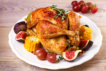 Chicken with figs, corn on cob, grape, plums and blackberry