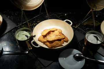 Delicious fried vegetable sliced eggplant in pan and sour cream