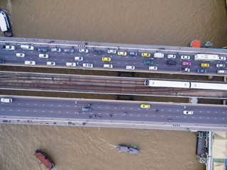 Birds-Eye Shot Of Traffic And BTS Skytrain On Saphan Taksin Bridge In Bangkok, Thailand