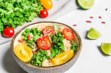 Colorful photo of a quinoa, goji berry, and kale vegetable salad in a bowl against white background. Healthy food, eating, fitness, diet, vegan, vegetarian, and superfood concept.