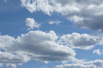 Cumulus clouds in a blue sky.