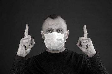 man in a black T-shirt and a medical mask