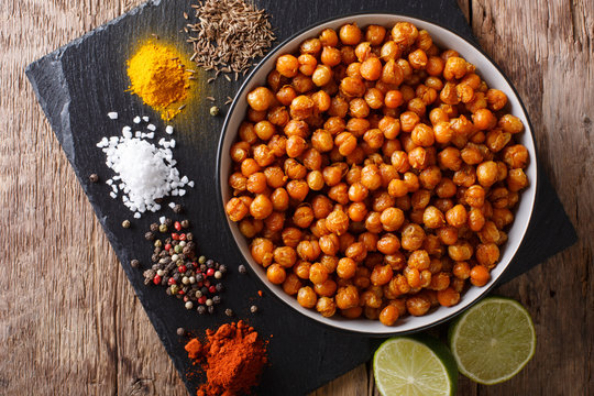 Fototapeta Snack of fried chickpeas with spices close-up in a bowl. horizontal top view