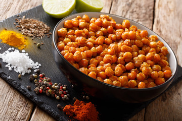 fried chickpeas with spices and lime close-up on the table. horizontal
