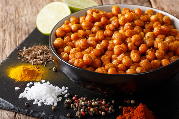 Snack of fried chickpeas with spices close-up in a bowl. horizontal
