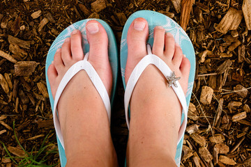 Young Girl's Bare Feet in Flip Flops