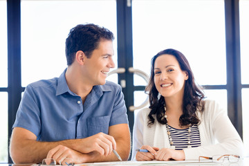 Image of two young business people in office