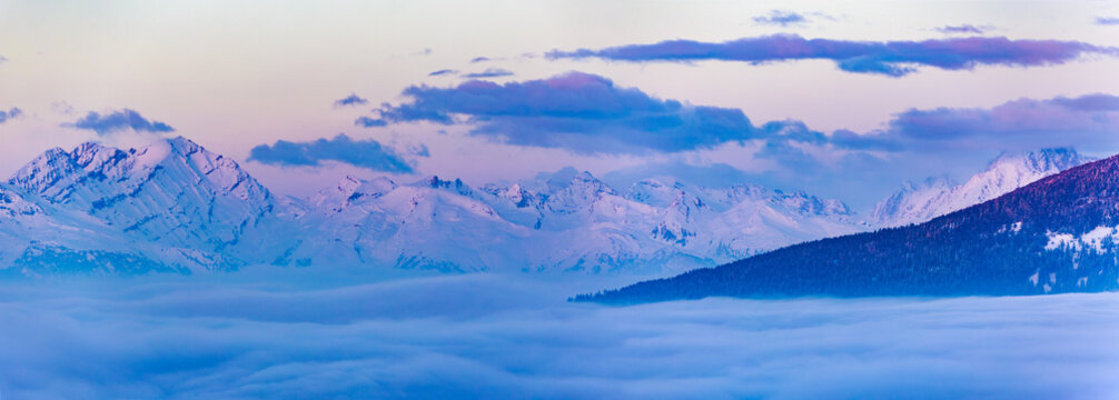 Scenic panorama sunset landscape of Crans-Montana range in Swiss Alps mountains with peak in background, Crans Montana, Switzerland.