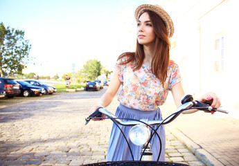 Charming woman on bike in city, during summer