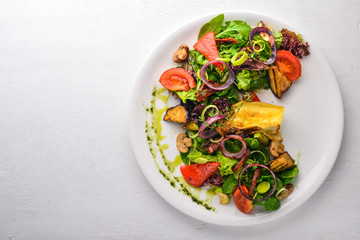 Brie cheese with grilled vegetables. Top view. Free space for text. On a wooden background.