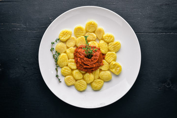 Potato dumplings. Top view. Free space for text. On a wooden background.