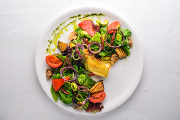 Brie cheese with grilled vegetables. Top view. Free space for text. On a wooden background.