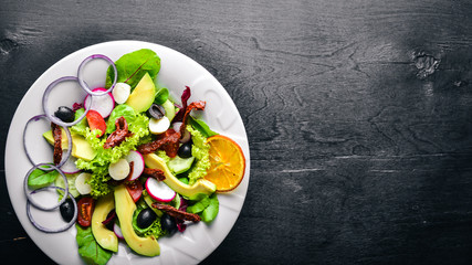 Avocado Salad with grilled meat and greens. Italian cuisine. Top view. On Wooden background.