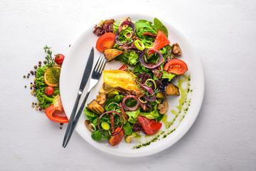 Brie cheese with grilled vegetables. Top view. Free space for text. On a wooden background.