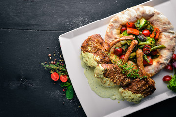 Veal steak on the bone. Grilled vegetables. Top view. Free space for text. On a wooden background.
