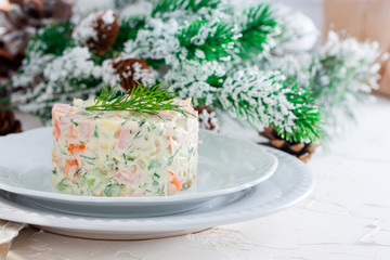 New Year's salad Olivier on a white plate, horizontal