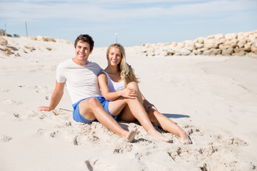 Romantic young couple sitting on the beach